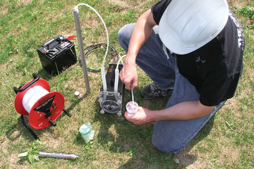 solinst peristaltic pump being used to take a groundwater sample from a drive point piezometer