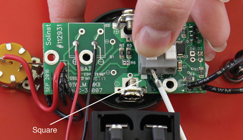press down on the white terminals of the water level meter circuit board and insert the tape and cable leads