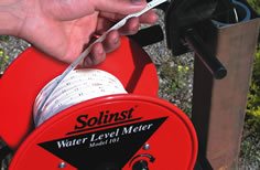 https://www.solinst.com/products/level-measurement-devices/102-water-level-indicator/images/flat-tape-water-level-meter.jpg