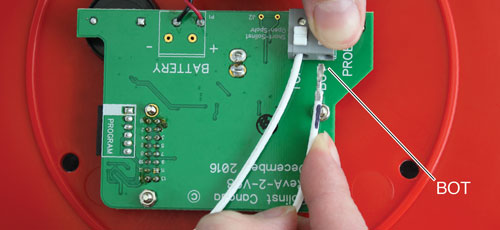 lead on bottom of the tape numbers facing up with black mark on lead is inserted into the terminal labelled bot on the solinst 201 water level temperature meter circuit board