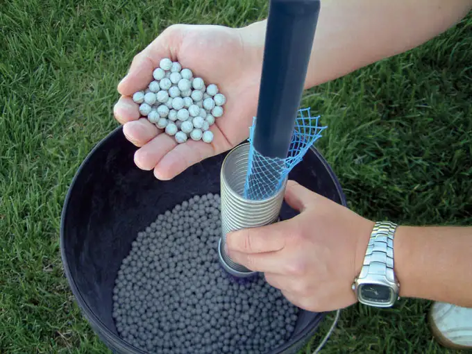 figure 36 pouring bentonite pellets into cmt multilevel system spring cartridge